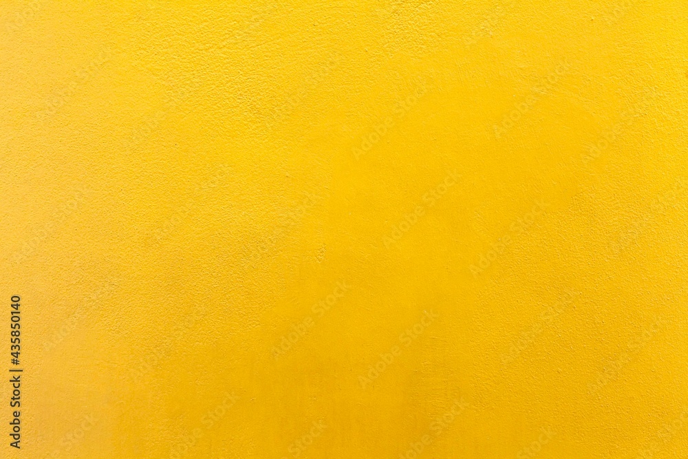 Wall mural Cement wall painted yellow texture and background seamless