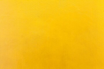 Cement wall painted yellow texture and background seamless