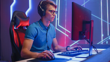 Professional eSports Gamer Plays Video Game on His Personal Computer, Raises Hands to Celebrate Victory after Winning a Round. Cyber Gaming Championship. © Gorodenkoff