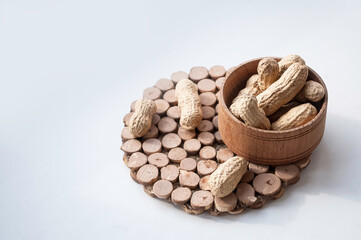 unpeeled peanuts on a white background