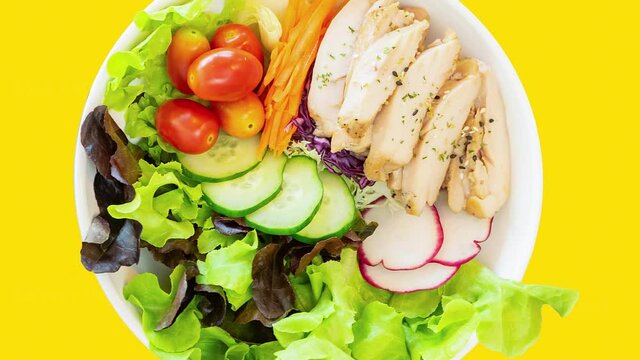 Spinning Chicken breast salad bowl on different isolated background.