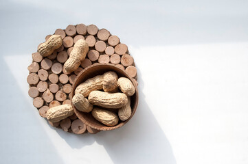 unpeeled peanuts on a white background