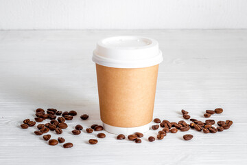 Paper cup with coffee beans. Close up