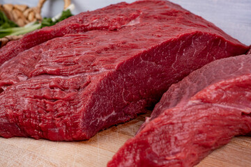 A piece of beef on the woden board