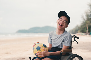Asian special child on wheelchair on the beach with parents in family holiday to travel, exercise...