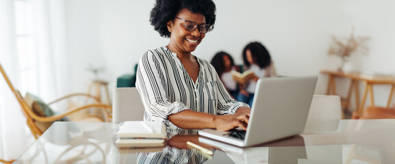 Happy woman working from home on laptop