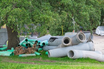 Loose pile of large drainage pipes on side of street in Uptown neighborhood of New Orleans