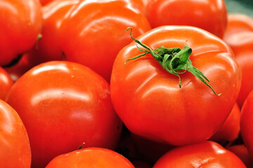 Fresh tomatoes in a market stall.