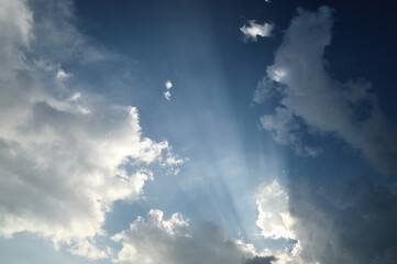 Sun rays through dark stormy clouds