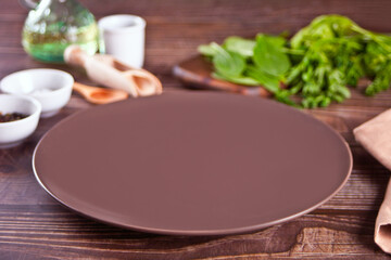 Table setting with brown plate with kitchen utensil on the wooden table