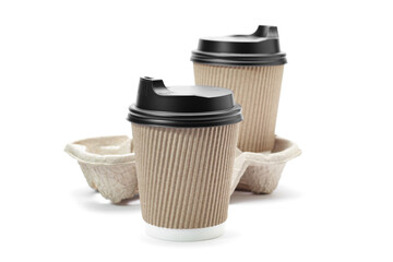 Disposable paper coffee cups with black caps and cardboard stand isolated on white background, focus in foreground. Takeaway coffee.