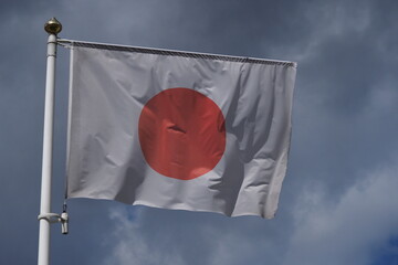flag of japan waving on blue sky