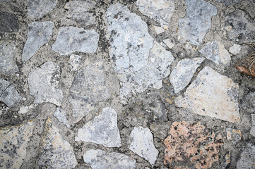 Texture of a stone wall. Old castle stone wall texture background. Stone wall as a background or texture. An example of masonry as a cladding of external walls.