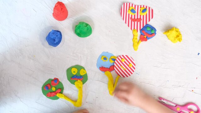 Child modeling fun craft . Modeling clay, plasticine and paper crafts idea for kids. Activity in kindergarten and at home. 
