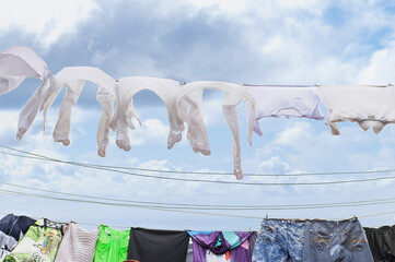 white clean linen is dried in the sun on a rope against blue sky in Havana
