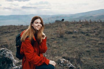 beautiful traveler with a backpack are resting in the mountains on nature landscape autumn