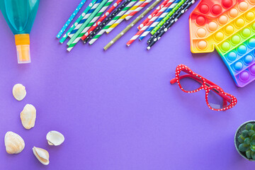 Fototapeta premium summer background mood, tropical leaf, sun glasses, seashells, fun accessories, travel vacation, ocean sea summer simple dimple pop it popit anti-stress sensory toy positive mood top view