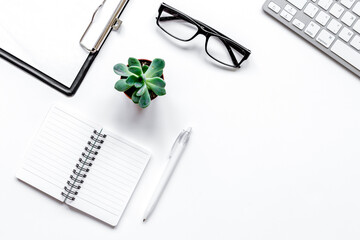 Workspace with glasses and notebook office desk white background top view mock up