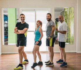 Fototapeta premium Group of people posing in a gym