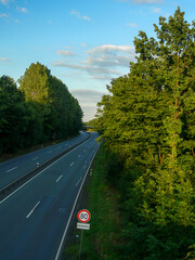 Empty federal road lined with trees in Germany