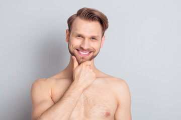 Photo of attractive handsome blond hair young guy no clothes smiling arm chin isolated grey color background
