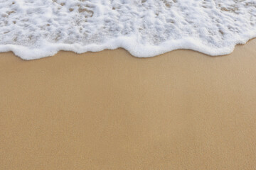 Fototapeta na wymiar Beautiful ocean waves on the sandy beach Abstract style nature background 