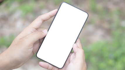 Hand holding and using smartphone with white blank on screen.
