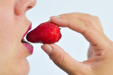 Close up of a handful of strawberries on a white background