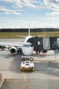 Douglas DC-6 aircraft tractor next to boarding aircraft in Wroclaw Airport