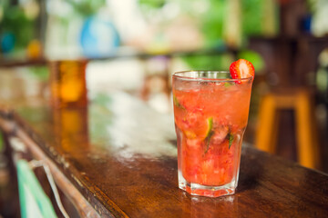 Colorful tropical cocktails on wooden bar. Mixology in pool holiday setting. Caribbean cocktails. Colorful cocktails in caribbean bar hotel