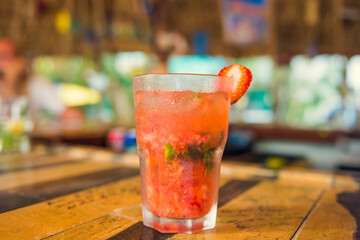 Colorful tropical cocktails on wooden bar. Mixology in pool holiday setting. Caribbean cocktails. Colorful cocktails in caribbean bar hotel