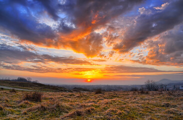 Colorful spring sunset with Sun rays coloring the clouds