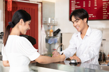 Fototapeta premium woman guest write signature for check in hotel from receptionist on paper