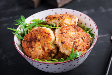 Healthy dinner. Chicken cutlets in a bowl on a dark background.