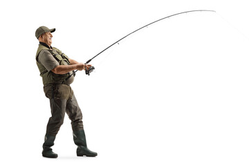 Full length profile shot of a mature fisherman in a uniform fishing - obrazy, fototapety, plakaty