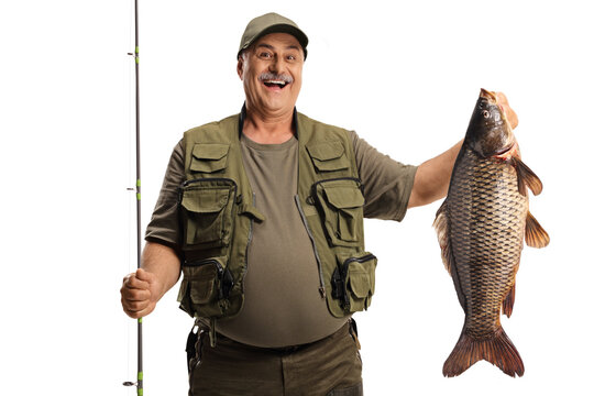 Happy fisherman holding a big carp fish and smiling