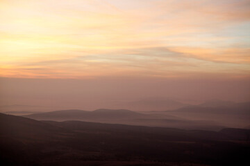 Fototapeta na wymiar view of foggy mountains at sunrise