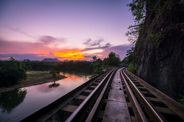 Thai Train in evening on River Kwai Bridge of Kanchanaburi, Thailand