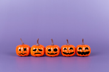 Pumpkin made from plastic with smile face emotico on purple background. Halloween and decoration concept. Service rating, feedback, satisfaction concept