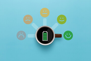 Cup of coffee with sign full level energy battery and smile face emoticon on blue background. Service rating, feedback, satisfaction concept. Top view