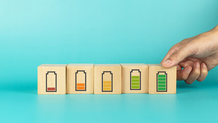 Hand hold wooden cube with full level energy battery green. Concept of work motivation, employee...