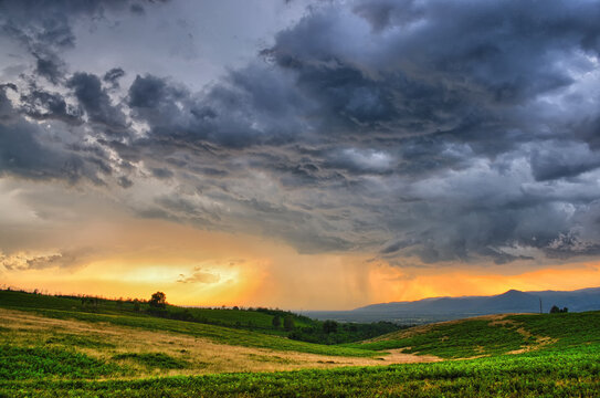 Dramatic storm scene with rain at the horizon