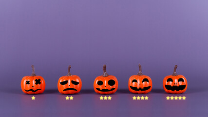 Pumpkin made from plastic with smile face emotico or with icon rating feedback scale on purple background. Halloween and decoration concept. Service rating, feedback, satisfaction concept