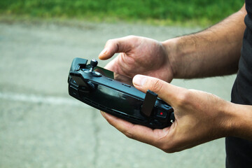a man controls the drone's remote control