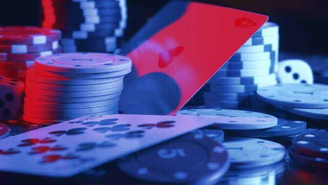 Casino chips and playing cards in motion. Concept of gambling or poker and entertainment. Close up macro shoot