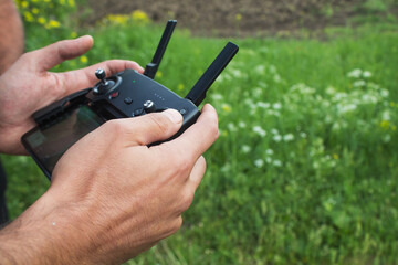 a man controls the drone's remote control