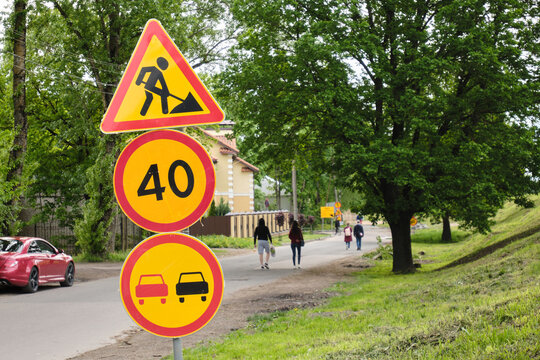 Road signs. Road works. Road warning signs. City streets. No overtaking. Speed limit.