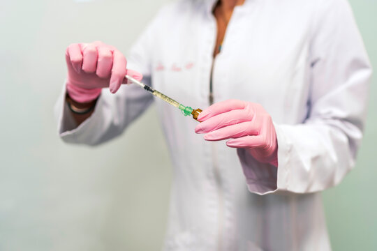 female doctor preparing doses of vaccine against covid19