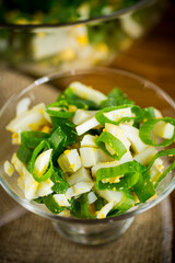 fresh spring salad with boiled squid, boiled eggs and green onions