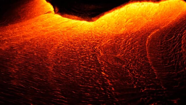 A river of incandescent lava pours out. Tons of hot magma spills